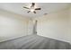 Spacious bedroom features neutral walls, plush carpeting, and a ceiling fan for added comfort at 5233 Los Palma Vista Dr, Orlando, FL 32837