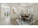 Elegant dining area features a modern light fixture, dining table with seating for six, and a view of other living areas at 5233 Los Palma Vista Dr, Orlando, FL 32837