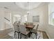 Bright dining area showcasing modern decor, a tray ceiling detail, with views of other open-concept living spaces at 5233 Los Palma Vista Dr, Orlando, FL 32837