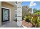 Close-up view of the decorative front door and well-manicured landscaping adding to the home's charm at 5233 Los Palma Vista Dr, Orlando, FL 32837
