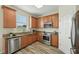 Modern kitchen boasts stainless steel appliances, wood cabinetry, and granite countertops for style at 5233 Los Palma Vista Dr, Orlando, FL 32837