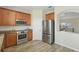 Well-equipped kitchen with stainless steel appliances and ample wood cabinetry for plenty of storage at 5233 Los Palma Vista Dr, Orlando, FL 32837