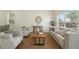 Bright living room with neutral-toned furniture, wood-look flooring, area rug, and a sunlit window view at 5233 Los Palma Vista Dr, Orlando, FL 32837