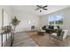 Modern living room with plush seating, stylish decor and wood-look tile flooring at 5233 Los Palma Vista Dr, Orlando, FL 32837