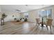 Bright living room with neutral tones, modern furnishings, and wood-look tile flooring throughout at 5233 Los Palma Vista Dr, Orlando, FL 32837