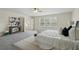 Light-filled main bedroom with a large window, stylish furnishings, and neutral carpet at 5233 Los Palma Vista Dr, Orlando, FL 32837
