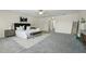 Spacious main bedroom with a large bed, bench, modern decor, and neutral carpet at 5233 Los Palma Vista Dr, Orlando, FL 32837