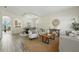 Open-concept living and dining area with modern decor, wood-look flooring, and abundant natural light at 5233 Los Palma Vista Dr, Orlando, FL 32837