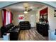 Comfortable living room featuring wood floors, a ceiling fan, and ample natural light at 701 N 7Th St, Haines City, FL 33844