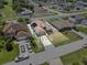 Aerial view of home with driveway and 3 vehicles surrounded by other homes and streets at 1955 Manatee Ct, Kissimmee, FL 34759