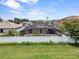 Backyard aerial view with screened-in pool and lush green grass and white fence at 1955 Manatee Ct, Kissimmee, FL 34759