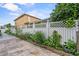 A backyard with a garden and a white fence at 1955 Manatee Ct, Kissimmee, FL 34759