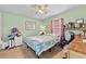 Comfortable bedroom with light green walls, ceiling fan, one window and carpeted floors at 1955 Manatee Ct, Kissimmee, FL 34759
