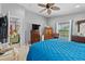 Inviting bedroom with a blue comforter, dresser, and a view of the pool, creating a serene and relaxing retreat at 1955 Manatee Ct, Kissimmee, FL 34759
