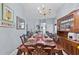 Formal dining room features an expansive table, chandelier, and built-in cabinet for elegant entertaining at 1955 Manatee Ct, Kissimmee, FL 34759