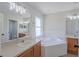 Bright bathroom boasts dual sinks, a soaking tub, and a separate shower for a spa-like experience at 316 Red Kite Dr, Groveland, FL 34736
