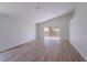 Vaulted living room featuring hardwood floors and sliding glass doors to the backyard at 316 Red Kite Dr, Groveland, FL 34736