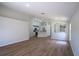 Open-concept living room with hardwood floors and seamless flow into the kitchen at 316 Red Kite Dr, Groveland, FL 34736