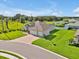Aerial view of home with a spacious yard, three-car garage, and brick paver driveway at 3544 Lakeside Heritage Dr, Lakeland, FL 33812