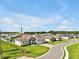 Aerial view of a home with a three-car garage, paver driveway, and green lawn at 3544 Lakeside Heritage Dr, Lakeland, FL 33812