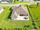 Aerial view of the rear exterior featuring a covered patio with an outdoor dining set at 3544 Lakeside Heritage Dr, Lakeland, FL 33812