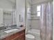 Bathroom featuring a shower-tub combo, single vanity with granite countertop, and neutral walls at 3544 Lakeside Heritage Dr, Lakeland, FL 33812