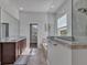 Bright bathroom featuring a double vanity, marble floors, soaking tub and glass-enclosed shower at 3544 Lakeside Heritage Dr, Lakeland, FL 33812