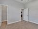 Bedroom featuring carpet, neutral walls, two doors, and an adjacent walk-in closet at 3544 Lakeside Heritage Dr, Lakeland, FL 33812