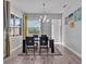 Dining room boasts a modern table and chairs, large windows, and an open view of the adjacent living area at 3544 Lakeside Heritage Dr, Lakeland, FL 33812