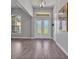 Bright foyer features soaring ceilings, a statement light fixture, elegant floors and abundant natural light at 3544 Lakeside Heritage Dr, Lakeland, FL 33812