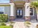 Charming home features a stone archway, stately columns and double front doors, creating an inviting entrance at 3544 Lakeside Heritage Dr, Lakeland, FL 33812