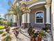 Beautiful home exterior features lush landscaping, stone accents and a welcoming covered entry way at 3544 Lakeside Heritage Dr, Lakeland, FL 33812