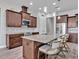 Spacious kitchen island features granite countertops, seating and stylish pendant lighting at 3544 Lakeside Heritage Dr, Lakeland, FL 33812