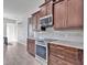 Modern kitchen features stainless steel appliances, granite countertops and updated fixtures at 3544 Lakeside Heritage Dr, Lakeland, FL 33812