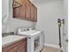 Well-equipped laundry room with front loading washer/dryer and convenient storage cabinets at 3544 Lakeside Heritage Dr, Lakeland, FL 33812