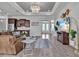 Open floor plan with living room and kitchen featuring a brown leather sectional and stainless steel appliances at 3544 Lakeside Heritage Dr, Lakeland, FL 33812