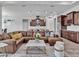 Open concept living room boasts stainless steel appliances and a large brown leather sectional and kitchen at 3544 Lakeside Heritage Dr, Lakeland, FL 33812
