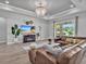 A spacious living room with a brown leather sectional and sliding glass doors to the outdoor area at 3544 Lakeside Heritage Dr, Lakeland, FL 33812