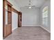Spacious living room is enhanced by elegant floors, a ceiling fan and built-in shelving at 3544 Lakeside Heritage Dr, Lakeland, FL 33812