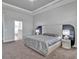 Spacious main bedroom features a tray ceiling, plush carpeting, and an ensuite bathroom at 3544 Lakeside Heritage Dr, Lakeland, FL 33812