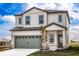 Charming two-story home with a gray garage door, manicured lawn, and welcoming entrance at 3808 Corsican Pl, Lake Alfred, FL 33850