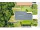 Aerial view of house showing a new grey roof and green grass at 4132 Festival Pointe Blvd, Mulberry, FL 33860