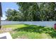 Spacious backyard with green grass surrounded by a new white fence at 4132 Festival Pointe Blvd, Mulberry, FL 33860