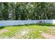 Large fenced backyard with green grass and playhouse at 4132 Festival Pointe Blvd, Mulberry, FL 33860