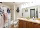 Bathroom with a double sink vanity, shower with tub, decorative shower curtain, and a toilet at 4132 Festival Pointe Blvd, Mulberry, FL 33860