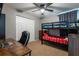 Bedroom with bunkbeds, closet, grey walls, ceiling fan, and a wood desk at 4132 Festival Pointe Blvd, Mulberry, FL 33860