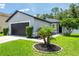 Charming single-story home with a well-maintained lawn and a two-car garage at 4132 Festival Pointe Blvd, Mulberry, FL 33860