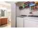 Washer and dryer in laundry closet with extra storage, located near half bathroom at 4132 Festival Pointe Blvd, Mulberry, FL 33860