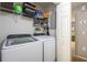Bright laundry room with front loading washer and dryer and a shelf with linens at 4132 Festival Pointe Blvd, Mulberry, FL 33860