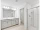 Modern bathroom featuring a double sink vanity, a toilet, and a glass-enclosed shower with shelving at 4732 Babys Breath Pl, Kissimmee, FL 34758